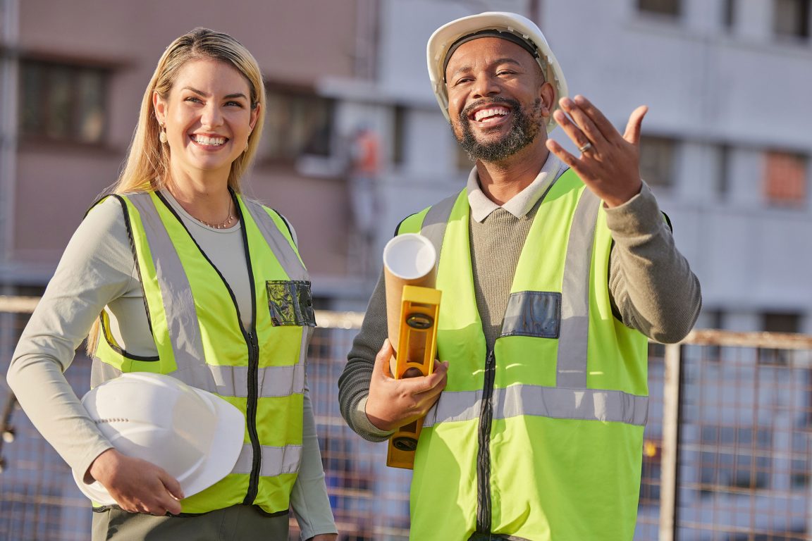Two workers collaborating and having a laugh